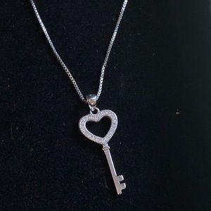 Silver key necklace.